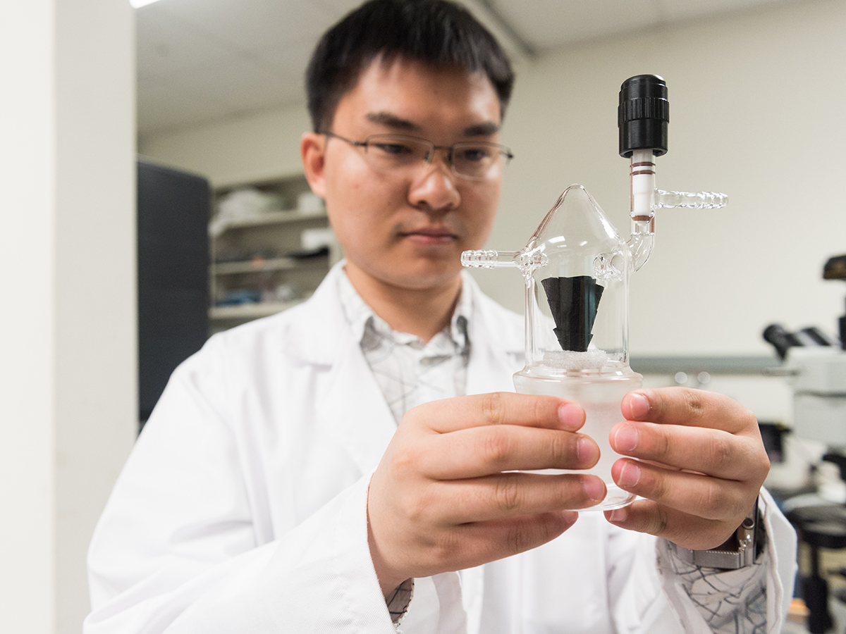 researcher holds device in hands